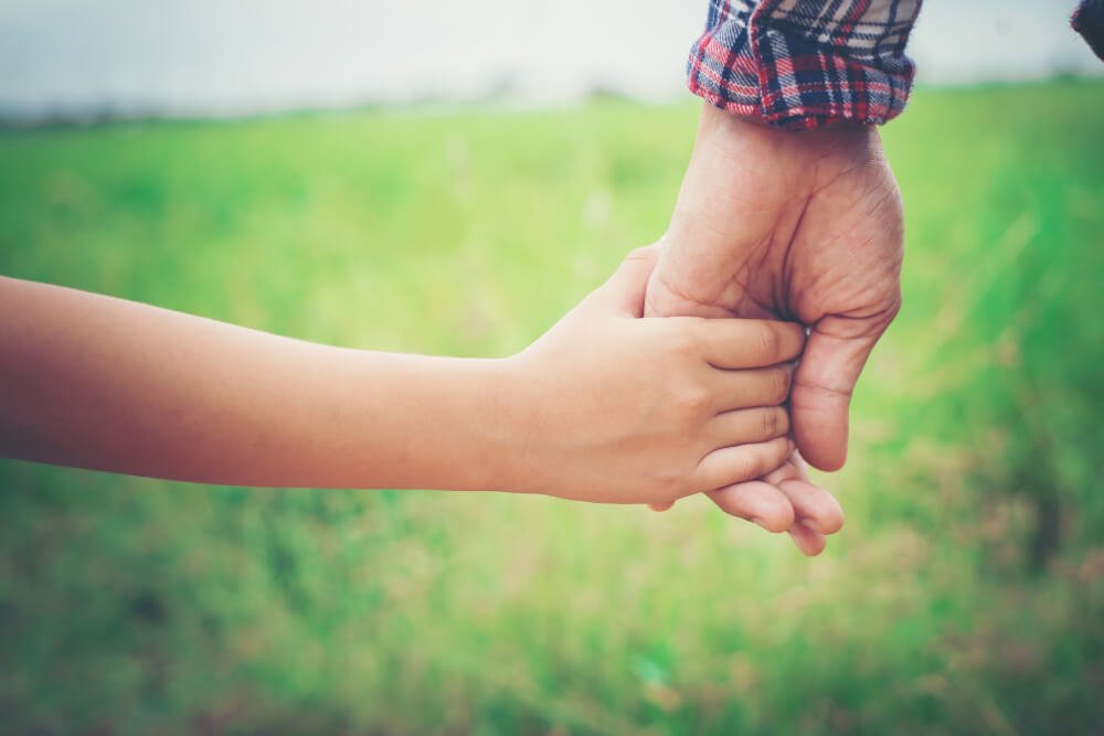 close up of father holding his daughter hand, for max life insurance